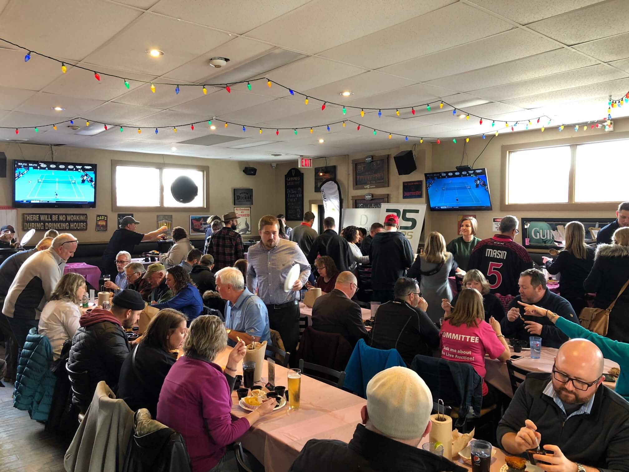 Busy restaurant full of people tasting chili